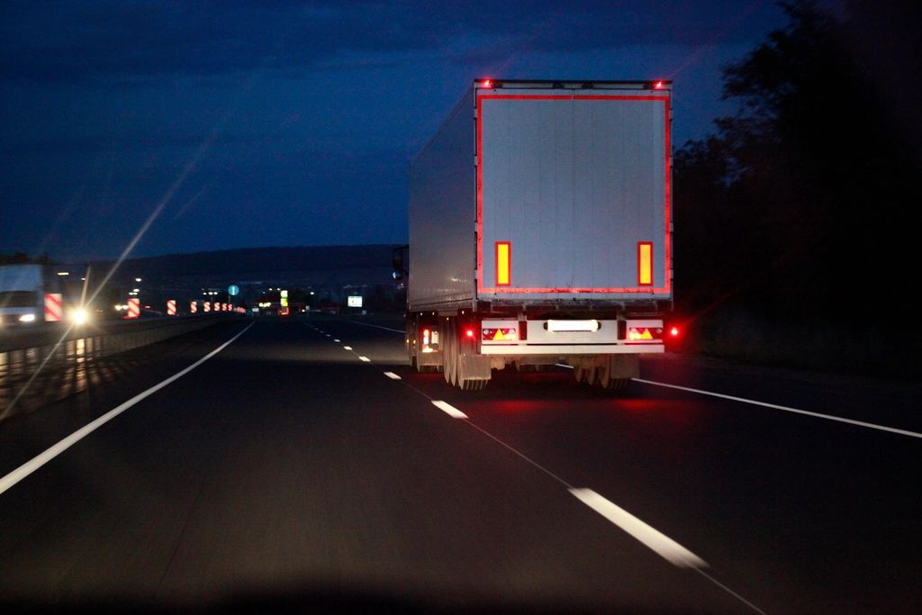 Loaded truck on a highway at night